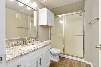 A bathroom with a toilet sink and shower